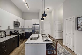 a kitchen and dining room with an island and a sink